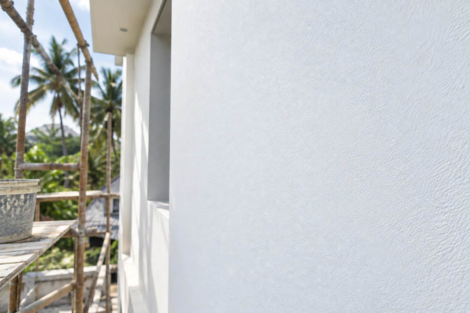 Extra opacity — the primed side burying patchy plaster the untreated side still shows