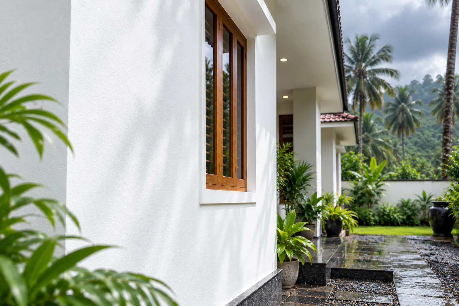Extra whiteness — a bright white elevation against monsoon greenery and hills